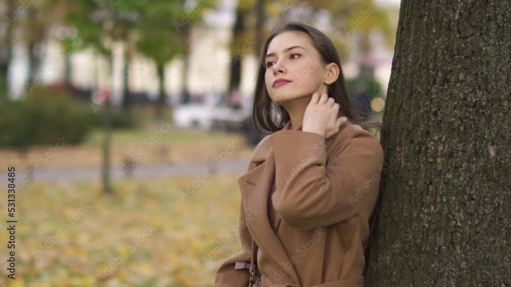 Portrait of a girl fixing her hair in an autumn landscape Portrait of a girl fixing her hair in an autumn landscape