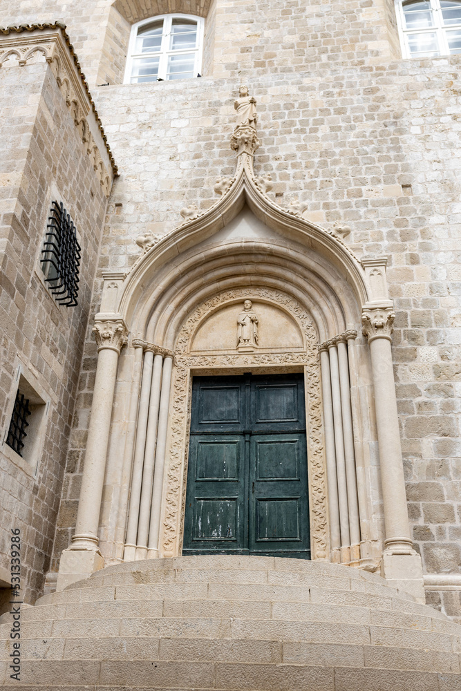 Dubrovnik, Croatia - September 21, 2021. The weathered green door marks the entrance to the Dominican Monastery in Old town was listed UNESCO World Heritage. King's Landing, capital Seven Kingdoms