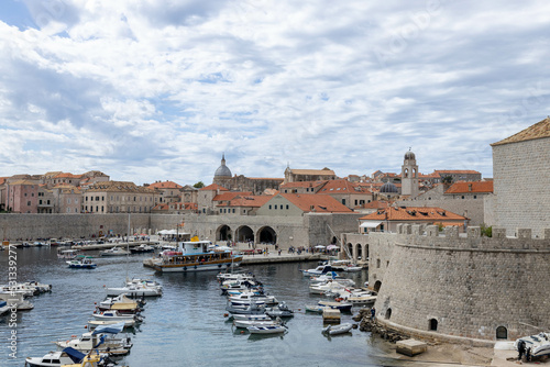 Dubrovnik  Croatia - September 21  2021  Croatian city on the Adriatic Sea with fortress. Panorama view. Boats and ships in harbor in old town. Prominent travel destination. UNESCO World Heritage Site
