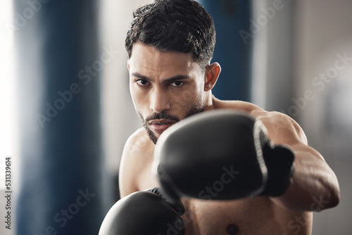 Boxing fitness, motivation portrait and man at the gym for wellness, health workout and sports exercise. Face of a strong boxer athlete with fist power during cardio fight and competition training