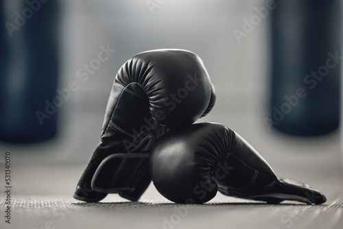 Canvastavla Boxing gloves on the floor of a gym after exercise, training and workout