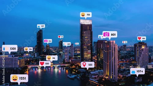 Social media icons fly over city downtown showing people reciprocity connection through social network application platform . Concept for online community and social media marketing strategy . photo