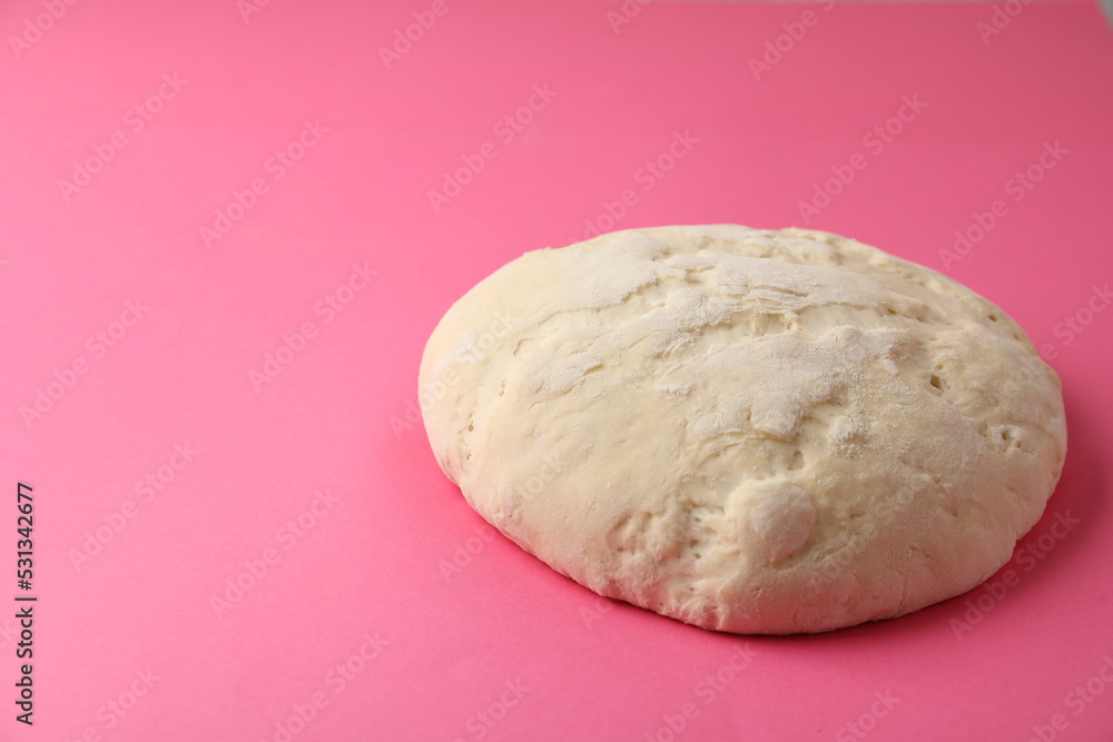 Raw dough for pastries on pink background. Space for text Raw dough for pastries on pink background. Space for text