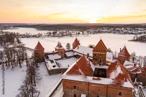 Beautiful aerial view of Trakai Island Castle, located in Trakai, Lithuania. Snow covered Galve lake on sunny winter sunrise. photo