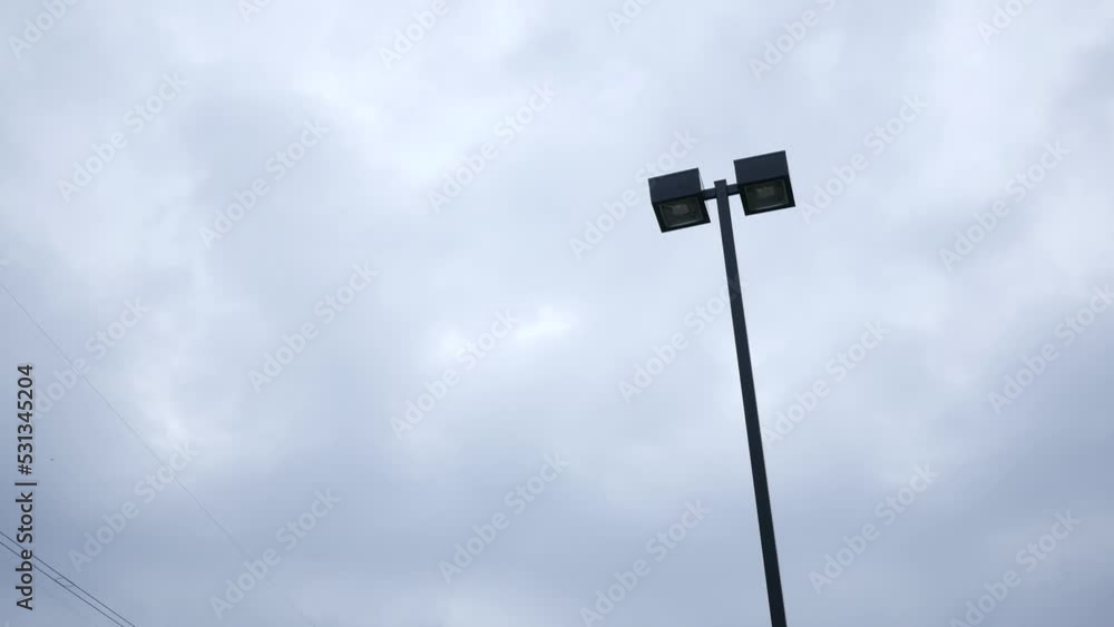A parking lot security light during overcast day A parking lot security light during overcast day