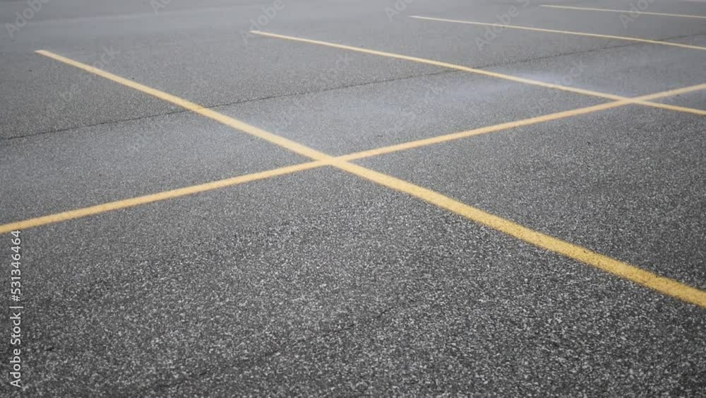 Camera pans over empty parking spots in shopping plaza or business Camera pans over empty parking spots in shopping plaza or business