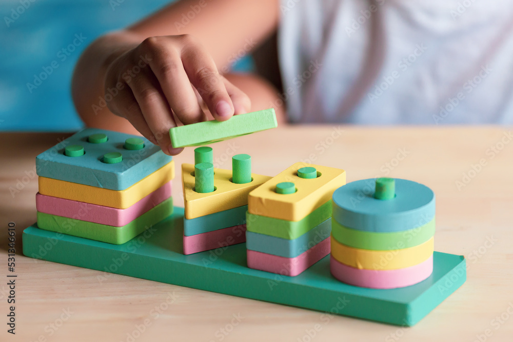 Naklejka premium boy playing children toys for learning for skills