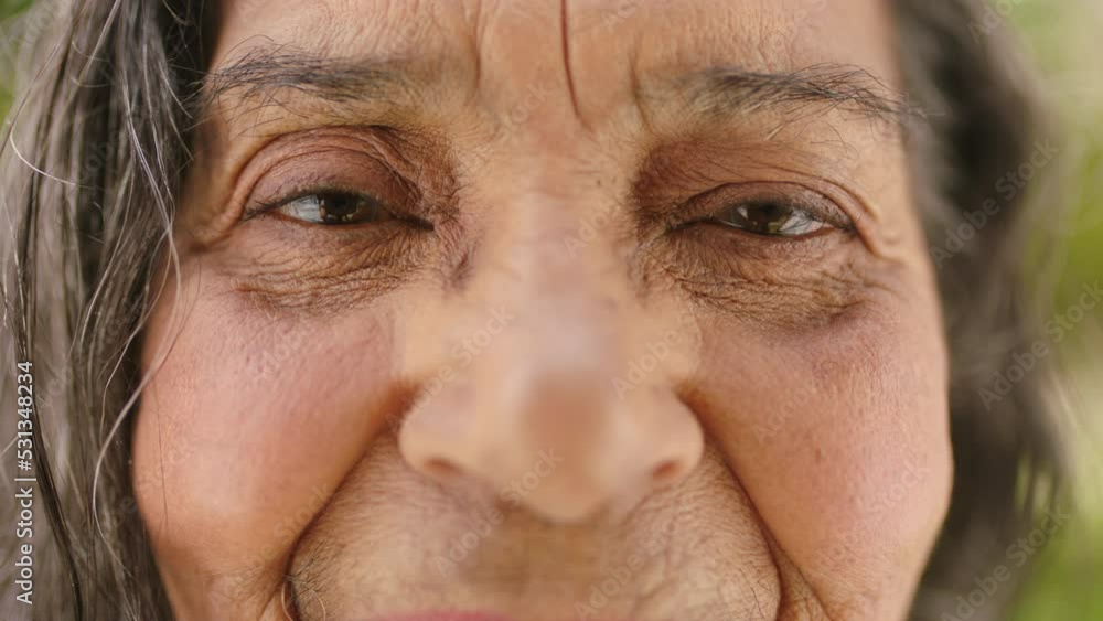 Old woman, wrinkles and macro portrait smile and cheerful person happy with retirement. Mature, aging skin and older lady enjoying senior citizen lifestyle outside in nature garden alone. Old woman, wrinkles and macro portrait smile and cheerful person happy with retirement. Mature, aging skin and older lady enjoying senior citizen lifestyle outside in nature garden alone.