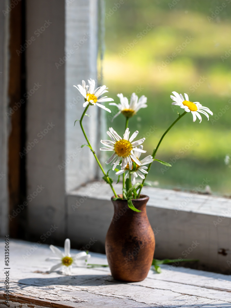 Beautiful retro still life with chamomile flowers in clay jug on windowsill of old window of country house, summer cottage. Close up, copy space. Floral home decoration. country life concept vertical Beautiful retro still life with chamomile flowers in clay jug on windowsill of old window of country house, summer cottage. Close up, copy space. Floral home decoration. country life concept vertical