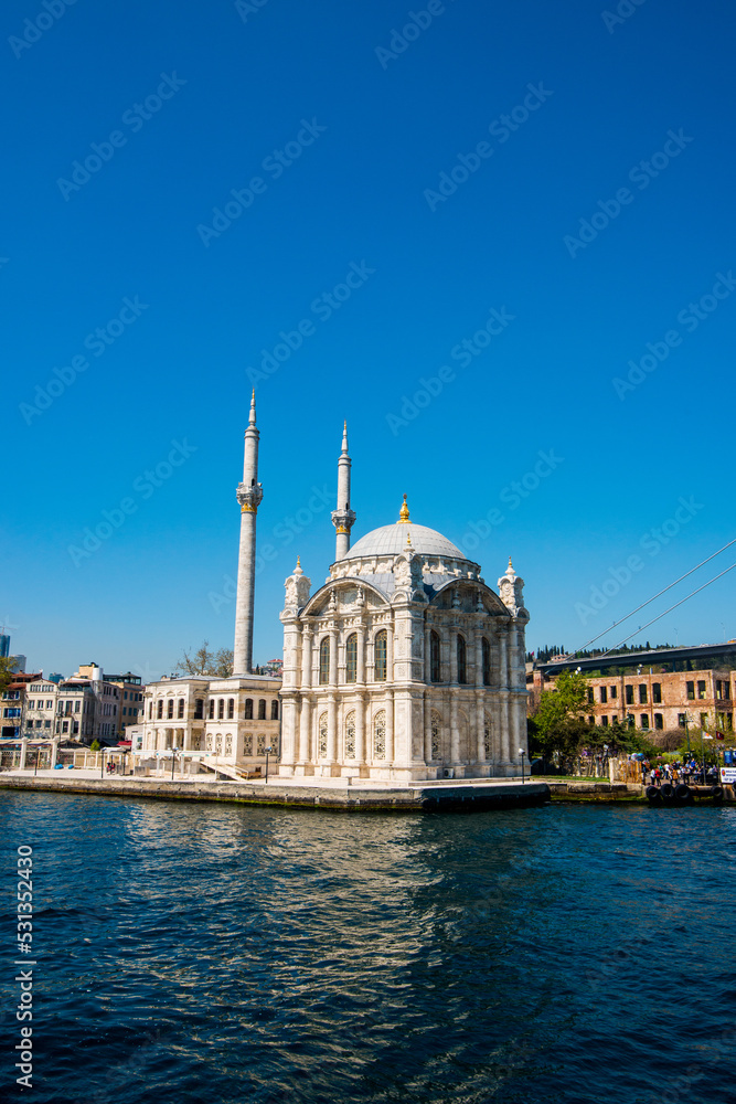Ortakoy Camii (mosque) under clear blue skies in Kadikoy, Turkiye.