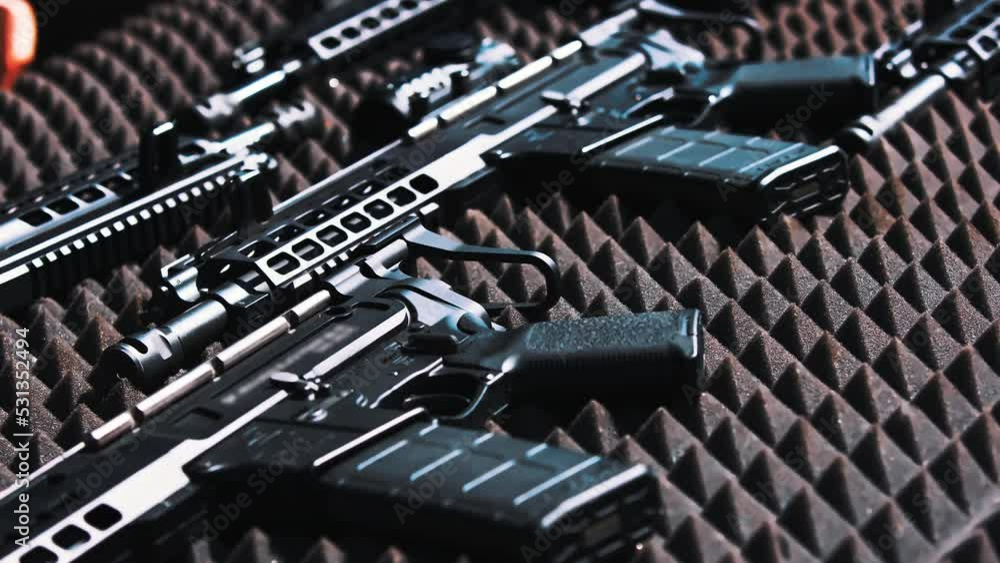 Shiny new professional black firearm put down on special grey foam to avoid scratching and breaking. Closeup outdoor shot. High quality 4k footage Shiny new professional black firearm put down on special grey foam to avoid scratching and breaking. Closeup outdoor shot. High quality 4k footage