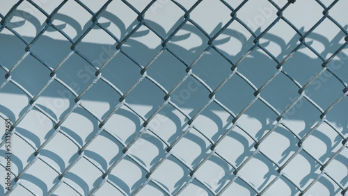 chain link fence and board with shadow