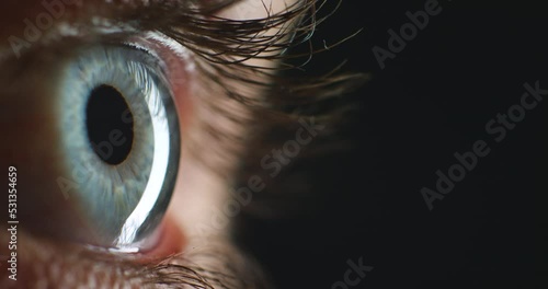 Blue eye, eyesight and vision of a woman with dilated pupils during optometry test for wellness and healthcare. Awareness with macro, zoom or closeup of medical examination of human iris anatomy photo