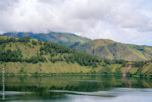 Fototapeta Naklejka Na Ścianę i Meble -  Scenic view of lake againts mountain and sky