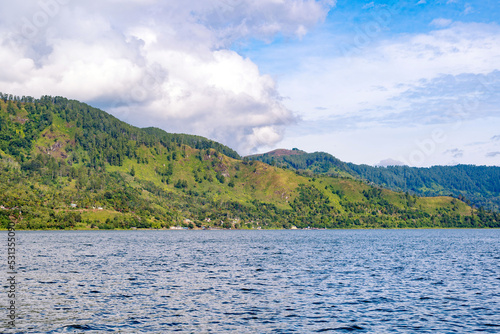 Scenic view of lake againts mountain and sky © Neilstha Firman