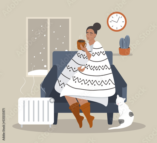 vector illustration in a flat style - a girl in a chair wrapped in a blanket next to her heater. winter outside