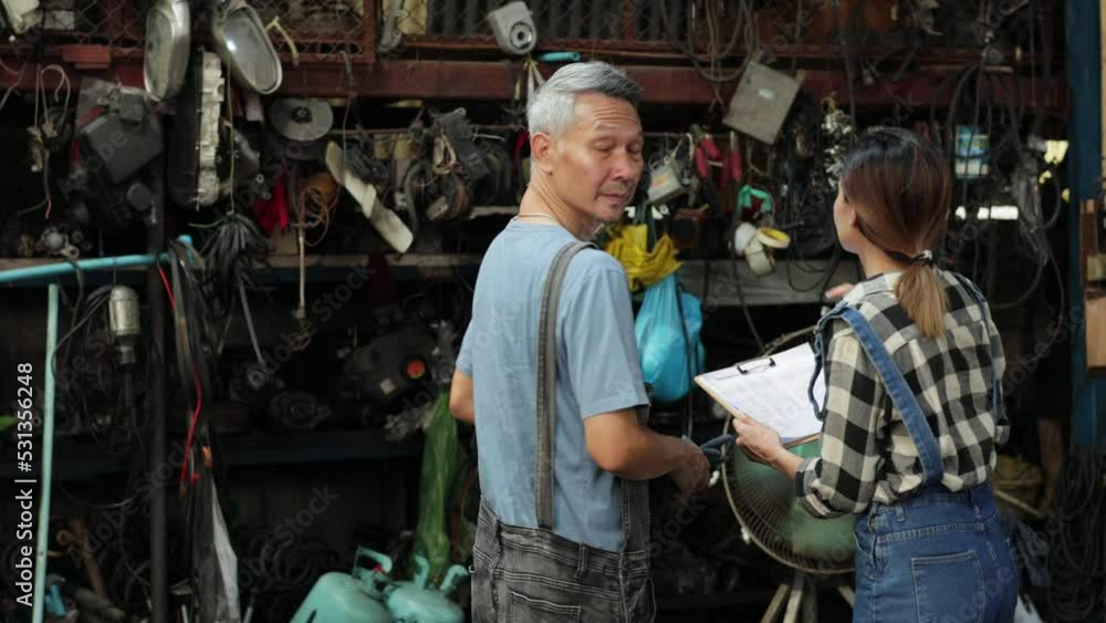 Handshake good deal and greeting. Asian young man customer talking with owner and mechanic worker at car repair service and auto store shop. Handshake good deal and greeting. Asian young man customer talking with owner and mechanic worker at car repair service and auto store shop.