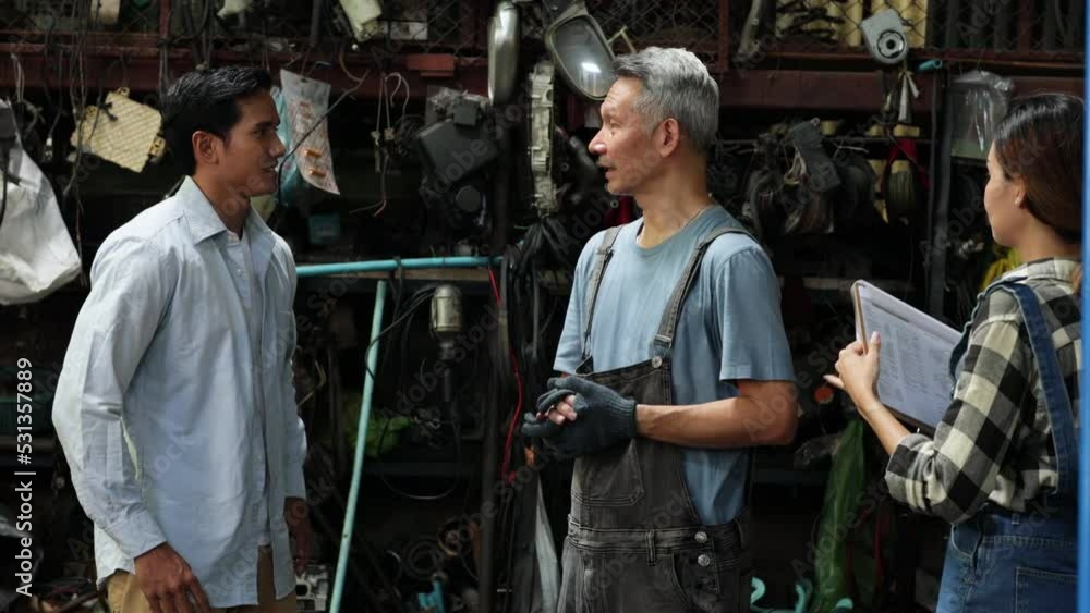 Handshake good deal and greeting. Asian young man customer talking with owner and mechanic worker at car repair service and auto store shop. Handshake good deal and greeting. Asian young man customer talking with owner and mechanic worker at car repair service and auto store shop.