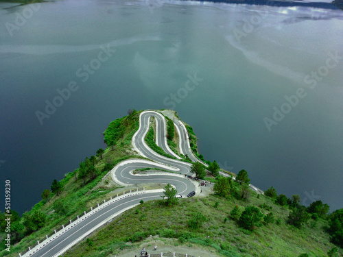 Aerial view of winding road on the hill photo