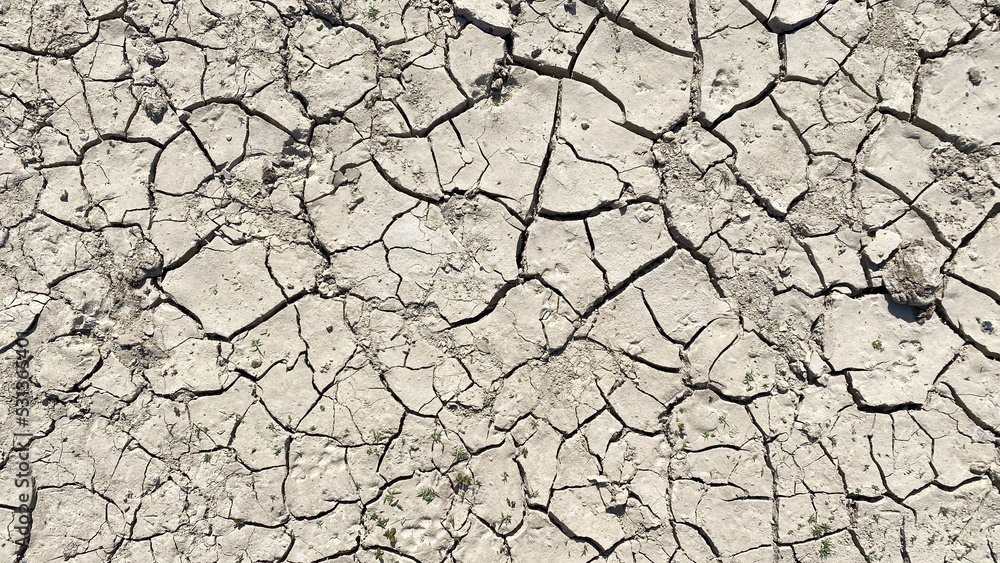 Cracks on the surface of the earth. Natural background. The dried up surface Cracks on the surface of the earth. Natural background. The dried up surface
