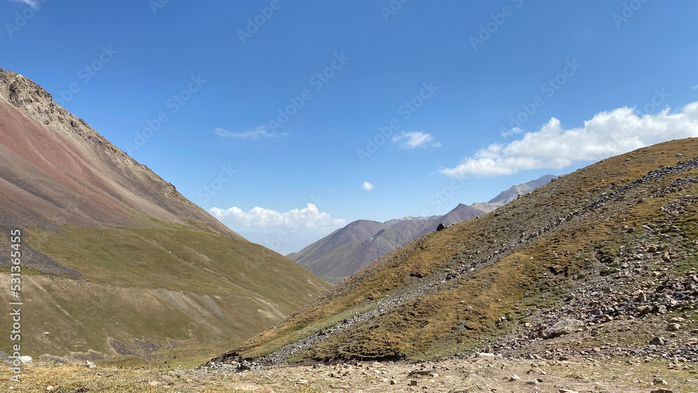 Green slopes and hills of Kyrgyzstan. trekking near the Base Camp on Lenin Peak. The amazing nature of the Pamirs. Green slopes and hills of Kyrgyzstan. trekking near the Base Camp on Lenin Peak. The amazing nature of the Pamirs.