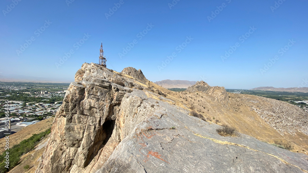 Fototapeta premium Beautiful powerful mountains. Sulaiman-Too is a rocky sacred mountain and a symbol of the city of Osh. View of the city from a bird's eye view.