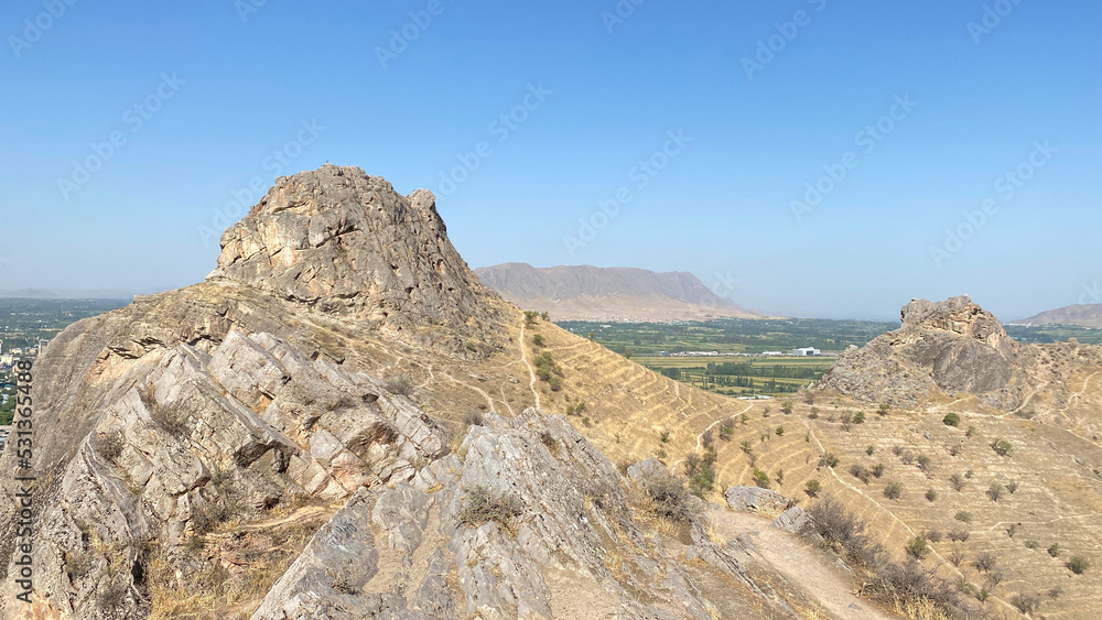 Rocky sacred mountain and symbol of the city of Osh - Sulaiman-Too. View of the city from a bird's eye view. Rocky sacred mountain and symbol of the city of Osh - Sulaiman-Too. View of the city from a bird's eye view.