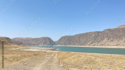 Panorama of the rocky mountains and hills of Kyrgyzstan. Beautiful mountain lake.