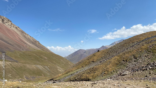 Green slopes and hills of Kyrgyzstan. trekking near the Base Camp on Lenin Peak. The amazing nature of the Pamirs.