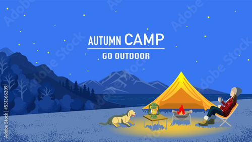 Young woman enjoying night camp in autumn with her dog - Included words