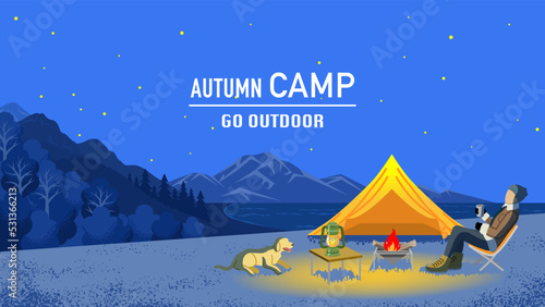 Young man enjoying night camp in autumn with his dog - Included words