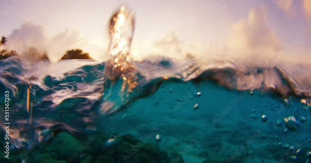 Split view of the tropical sea and island during sunset in the Maldives