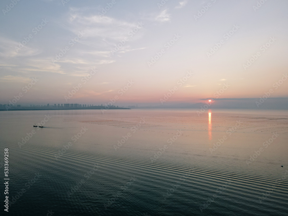 Aerial Drone Sunset View of the Pacific Ocean and the Skyline of Yantai City on Yangma Island, Shandong Province, China