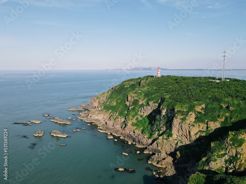 Aerial Drone View of Lighthouse, Ocean, Cliff on Jiming Island, Weihai, Shandong Province, China photo