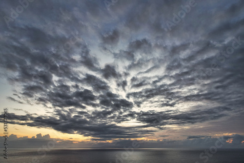 Beautiful red epic sunset sunrise and dramatic clouds over the dreamy sea - Bali