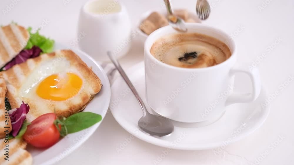 Woman puts brown sugar in a cup with hot aromatic coffee Woman puts brown sugar in a cup with hot aromatic coffee