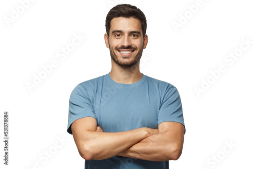 Fotografiet Smiling handsome man in blue t-shirt standing with crossed arms isolated