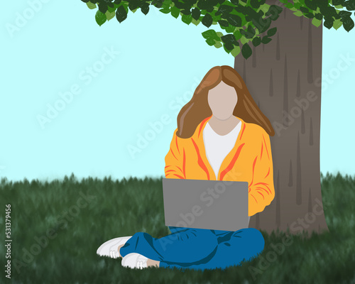 Faceless woman working on laptop in a park under a tree 
