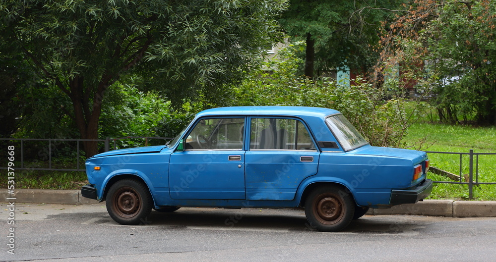 An old blue Soviet car is parked on the street, Bolshevikov Avenue, St. Petersburg, Russia, september 2022 An old blue Soviet car is parked on the street, Bolshevikov Avenue, St. Petersburg, Russia, september 2022