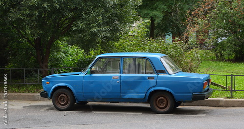An old blue Soviet car is parked on the street, Bolshevikov Avenue, St. Petersburg, Russia, september 2022