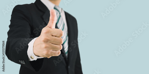 business man wearing black suit thumbs up like