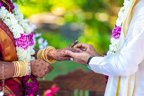 South Indian Tamil couple's exchanging wedding rings hands close up