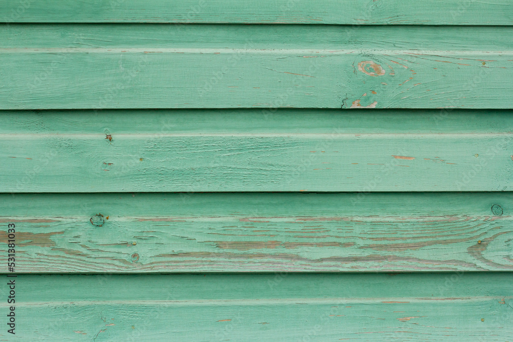 Fototapeta premium An old wooden wall painted turquoise, weathered wooden background.