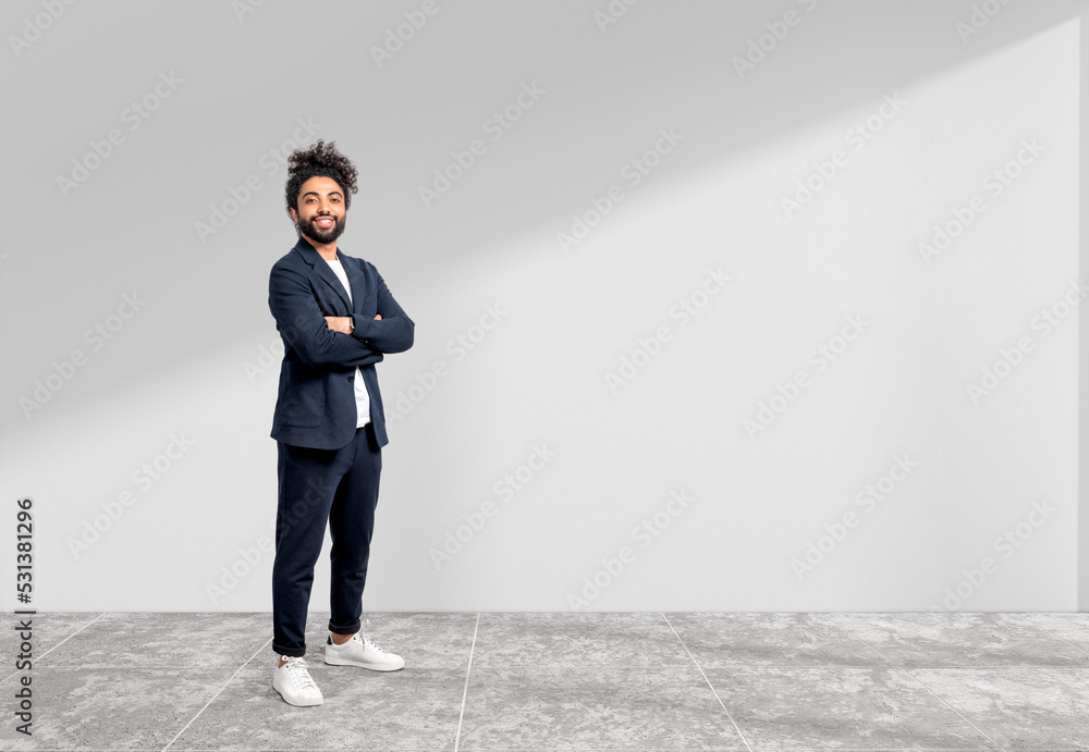 Smiling handsome businessman is standing in crossed arms pose Smiling handsome businessman is standing in crossed arms pose