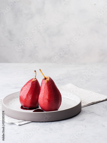 Composition with sweet poached pears on light background