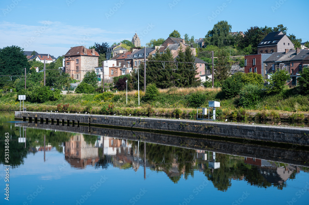 Namur, Wallon Region, Belgium,  Worker houses reflecting in the banks of the River Sambre