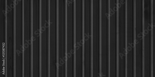 Vertical black siding texture, wooden, plastic or metal surface of a building or fence. Wall decoration for the facade. photo
