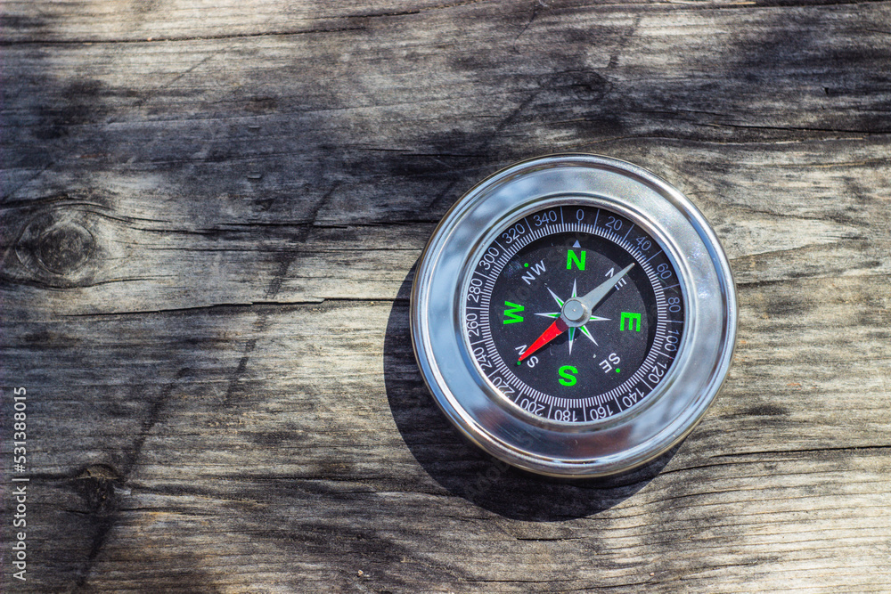 navigational compass on wooden board navigational compass on wooden board
