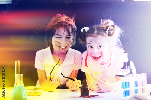 Background with highlights of children of scientists. A boy and a girl are experimenting in the laboratory.