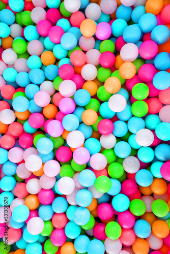 Multi-colored  highly saturated plastic balls  in soft play ball pit  at a child s play park. Colorful balloon.